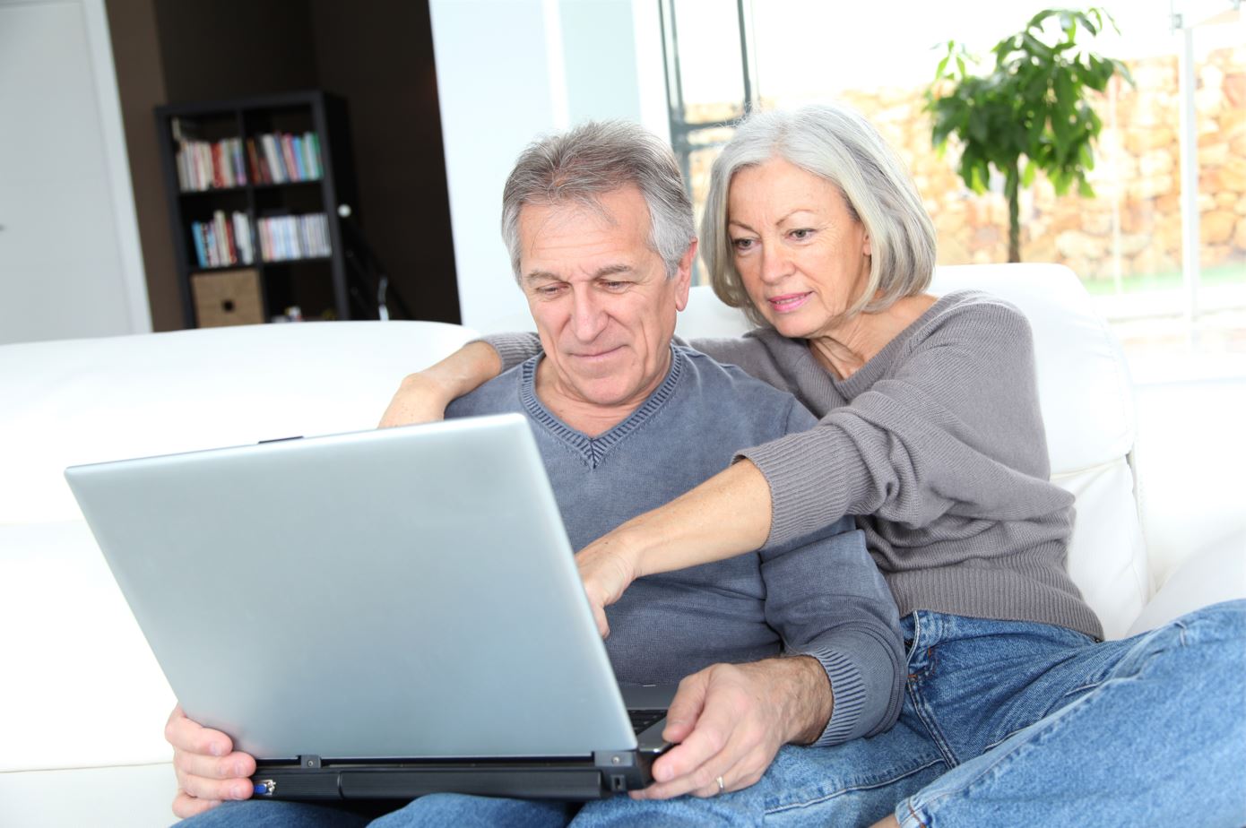 Senior couple surfing on internet at home